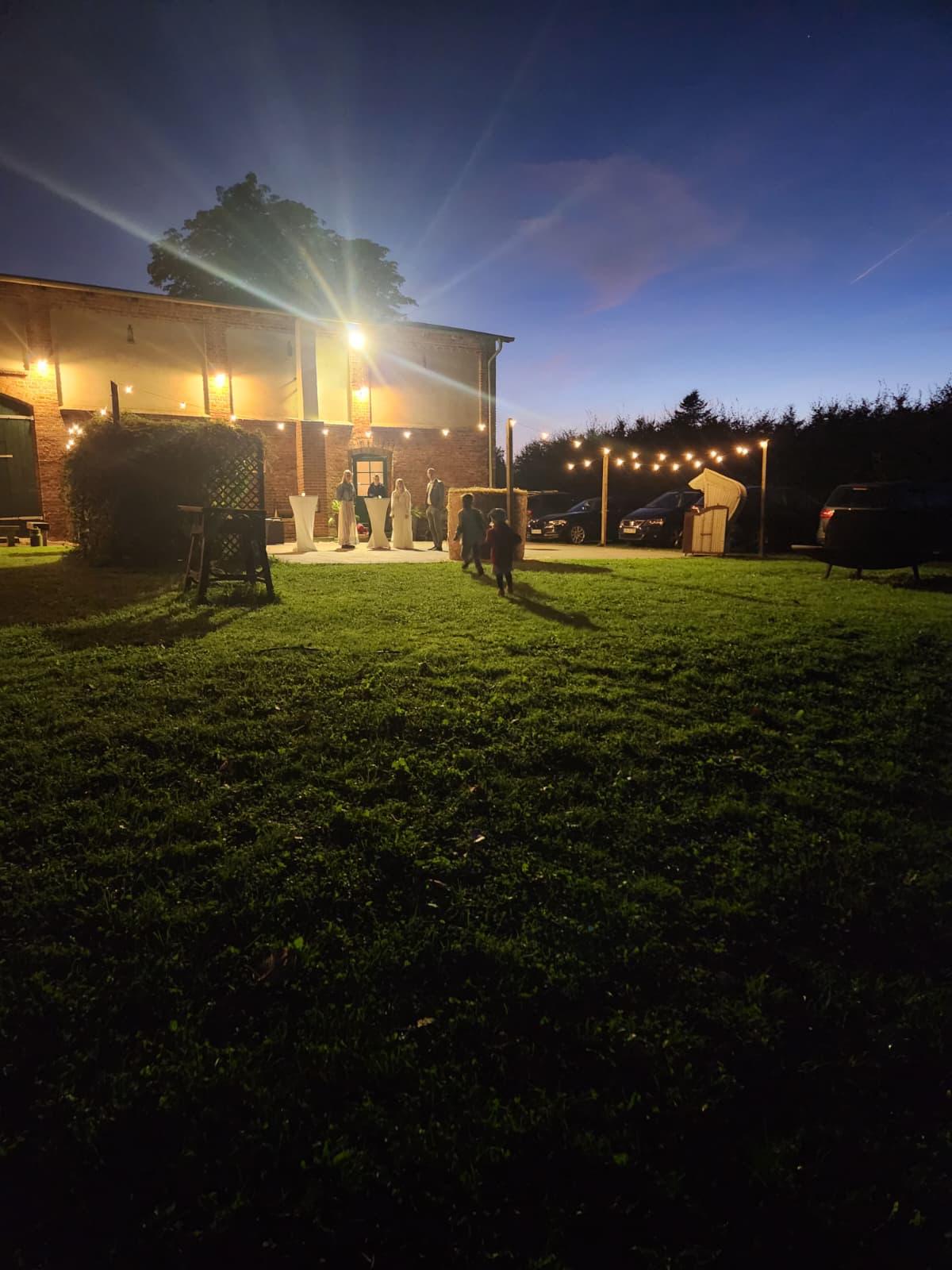 Abendstimmung mit Lichterketten am Hof